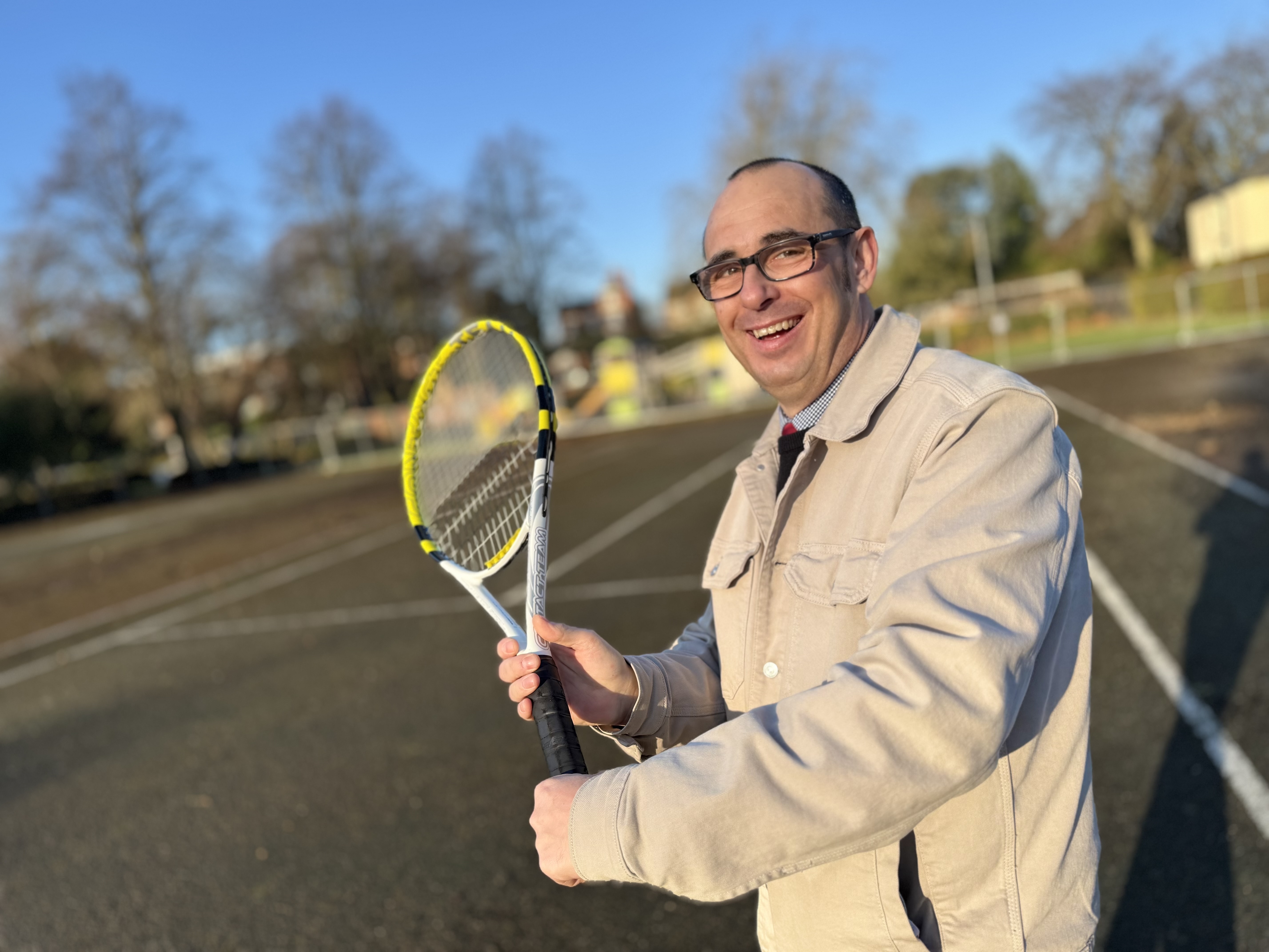 Cllr Wheeler with Tennis racket on courts